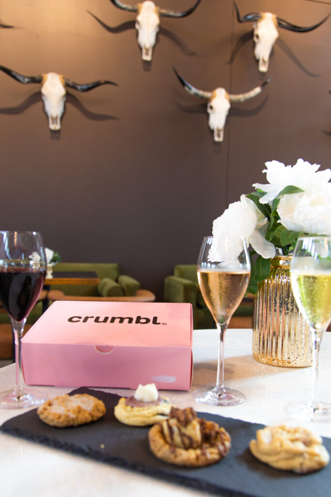 Cookies displayed with Wine on a table.